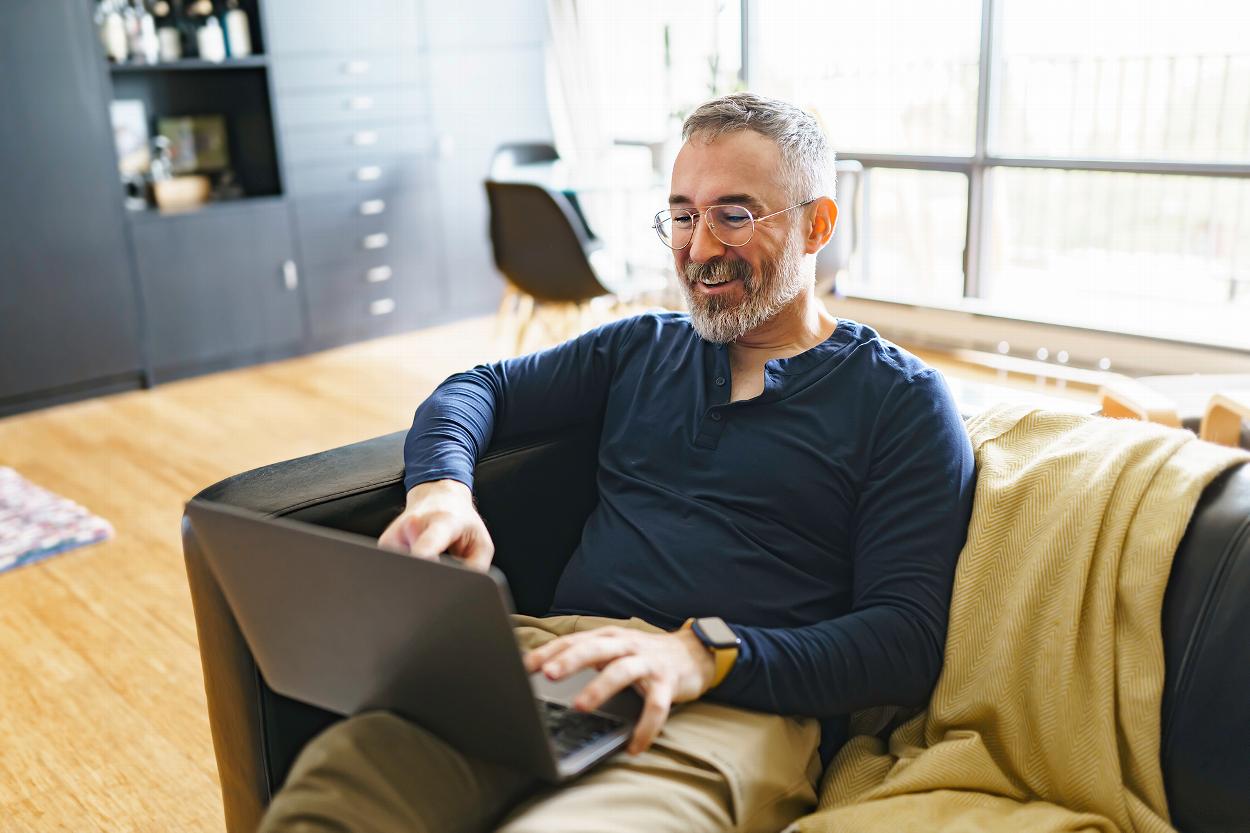 Middle-aged man using laptop for online counselling call
